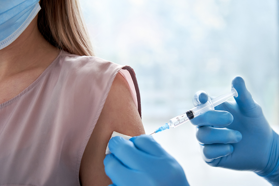 Woman getting corporate flu vaccinations